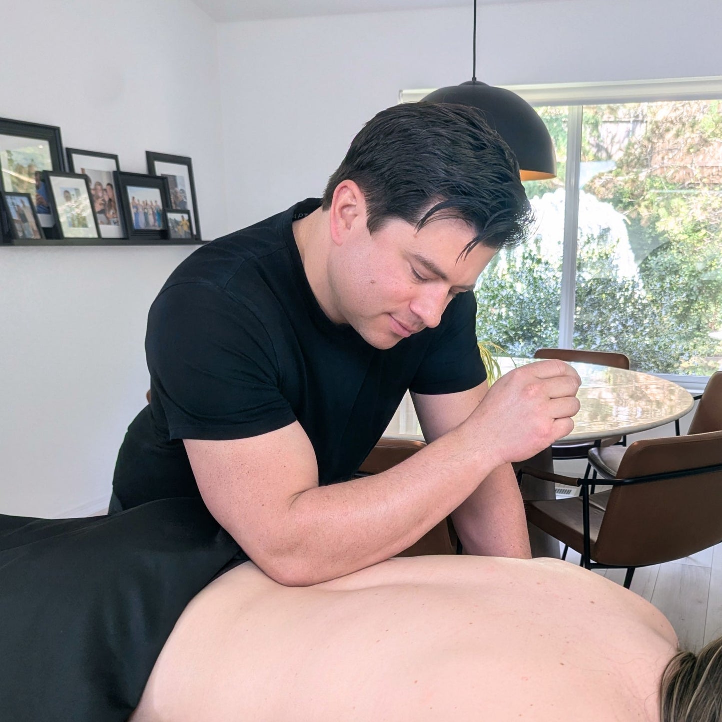 Clinical back massage treatment provided by Dan at a client's residence in Bellevue.
